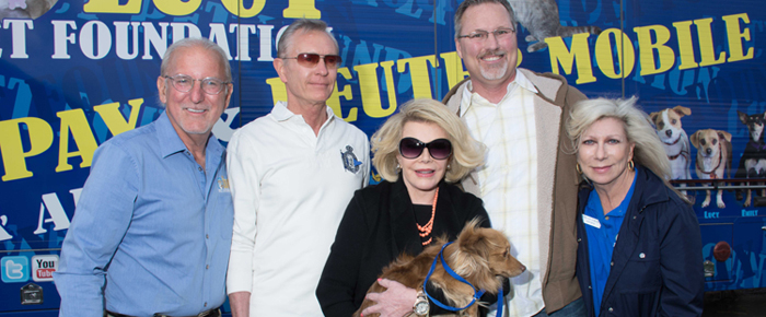 Joey Herrick and Joan Rivers in front of spay mobile