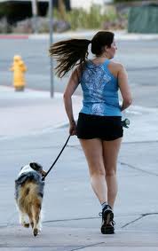 WSoman jogging with dog