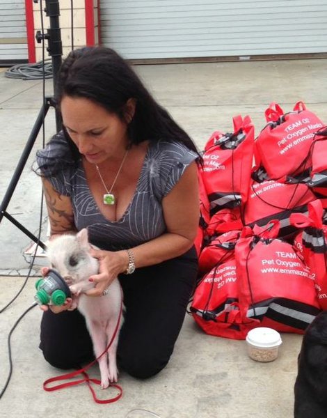 Debra with Pig wearing oxygen mask