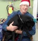 Dr. Marty Becker wearing Santa Hat with dog