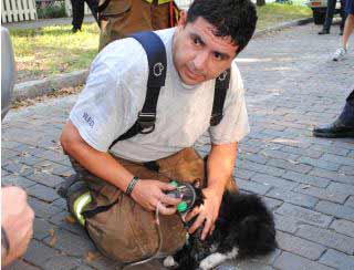 Fireman Oscar Cerda saves cat from fire