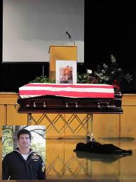 Hawkeye grieving at casket.660