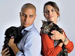 Man with dog; woman with cat